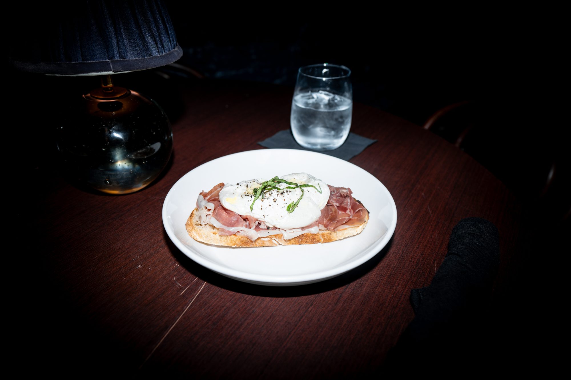Toasted bruschetta topped with prosciutto and a poached egg