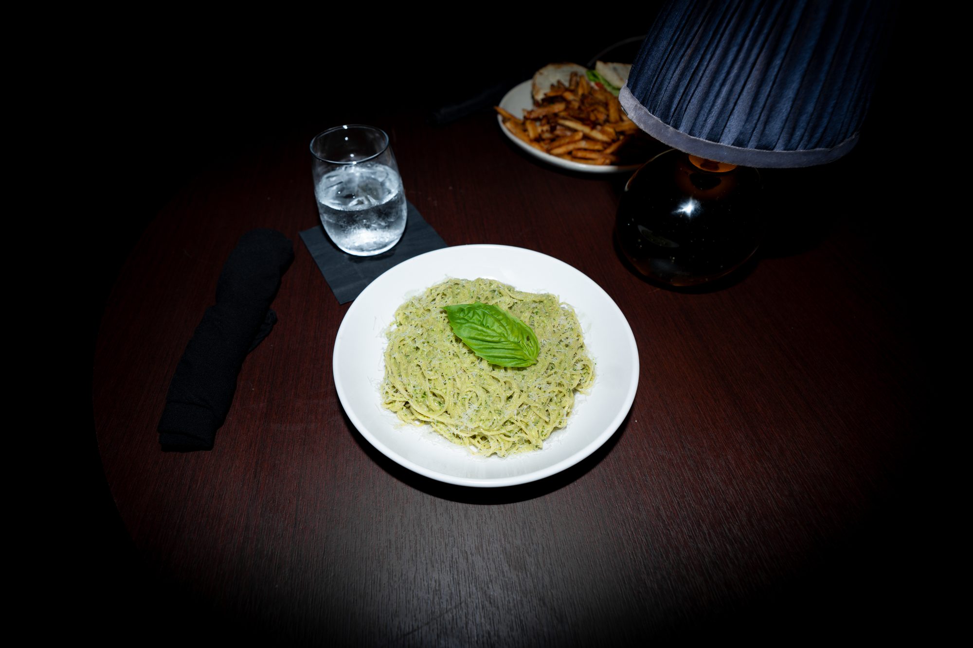 Basil pesto pasta finished with a fresh basil leaf