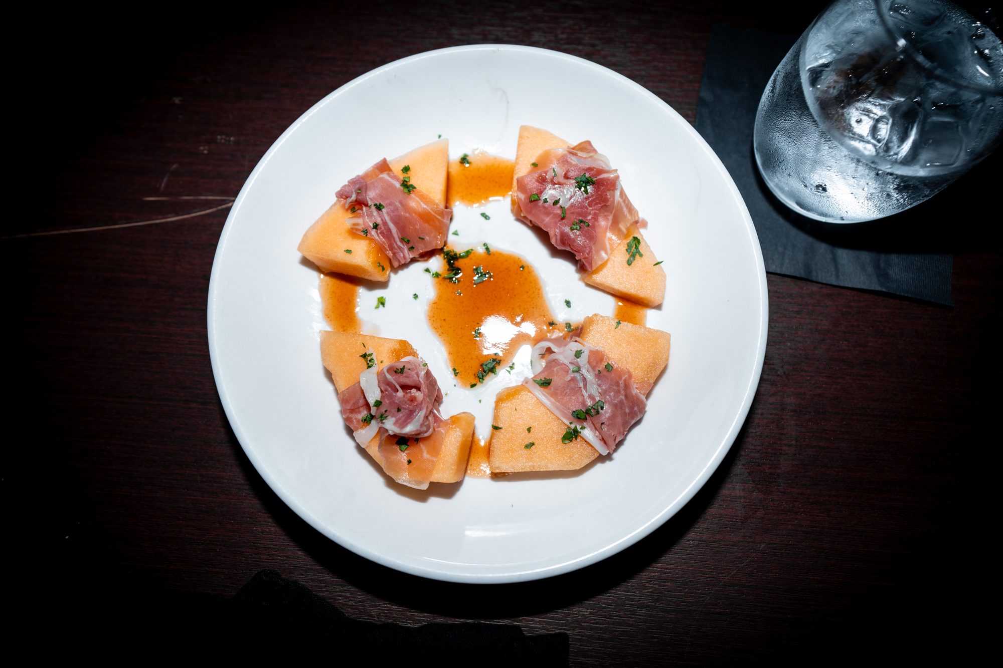 Prosciutto draped over fresh melon