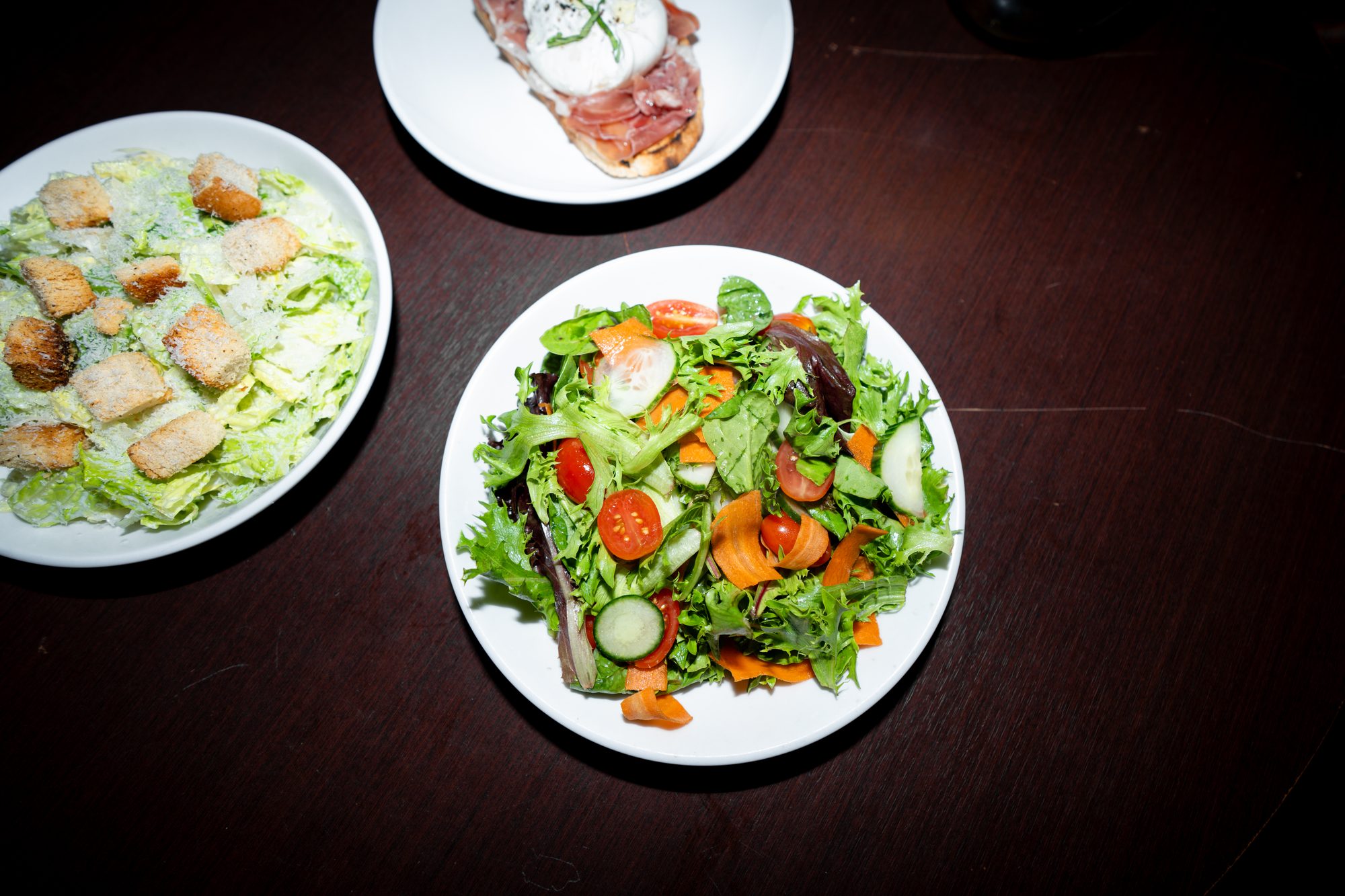 Caesar and garden salads served side by side