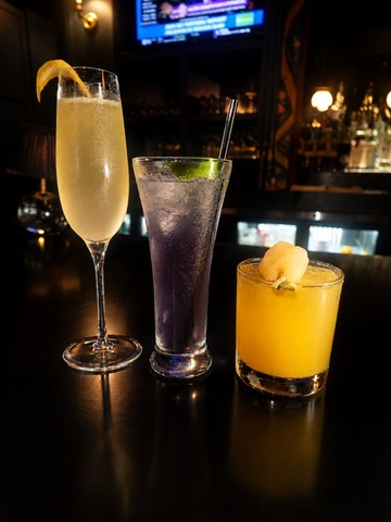 Trio of craft cocktails lined up on the bar