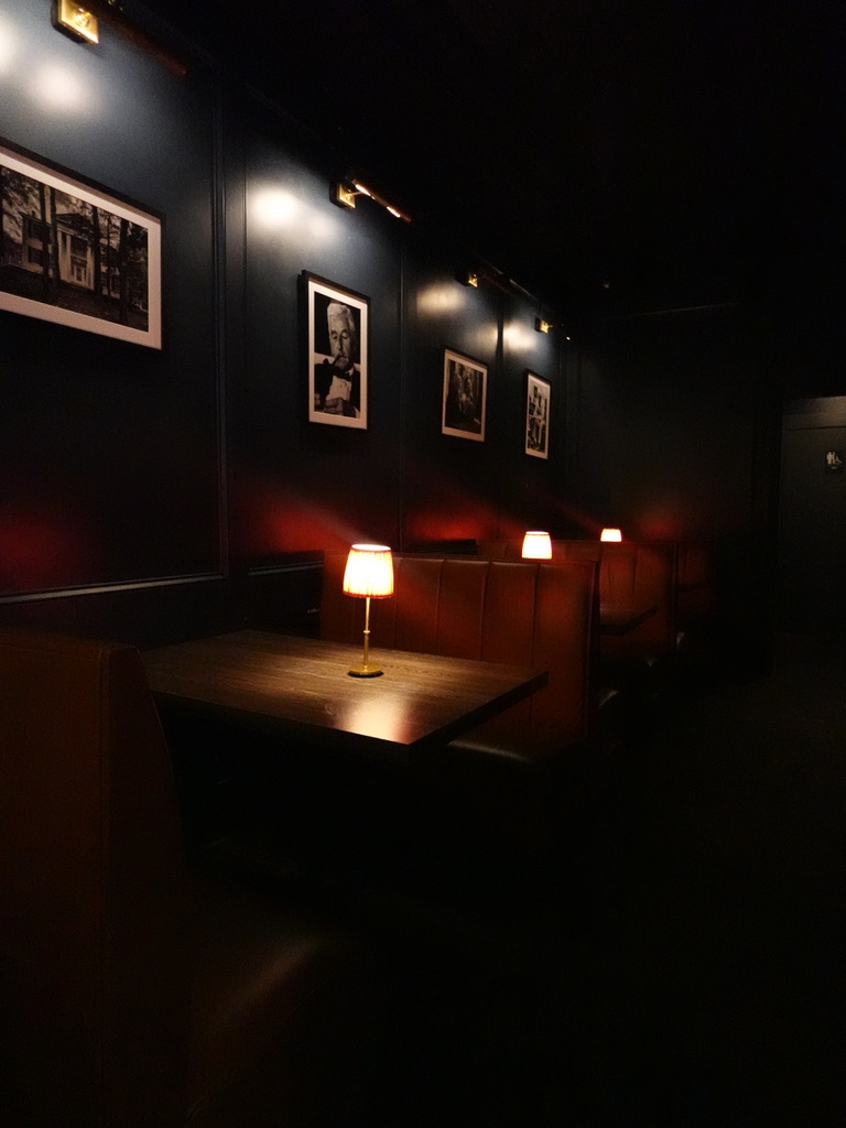 Moody evening light across the empty dining booths