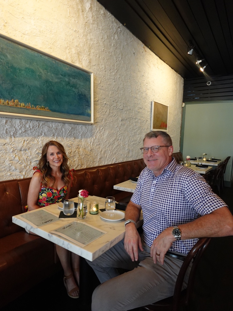 Guests seated in a sunlit booth at Estelle's Oxford