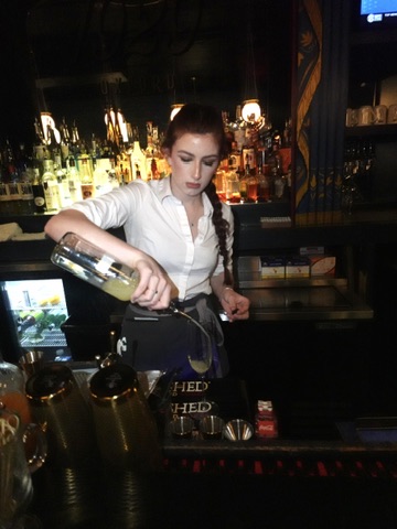 Bartender pouring a drink at Estelle's Oxford