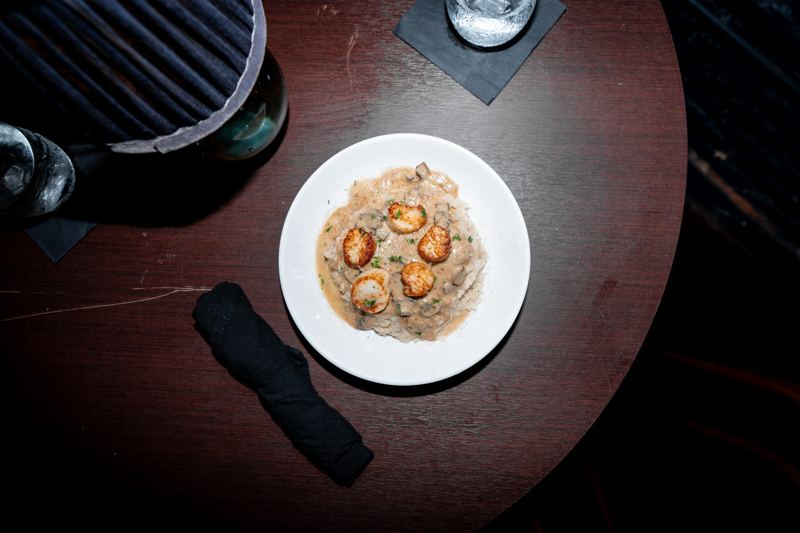 Creamy seafood risotto plated under warm lamp light