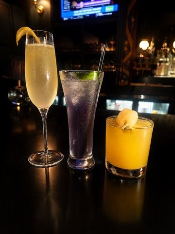 Trio of craft cocktails lined up on the bar