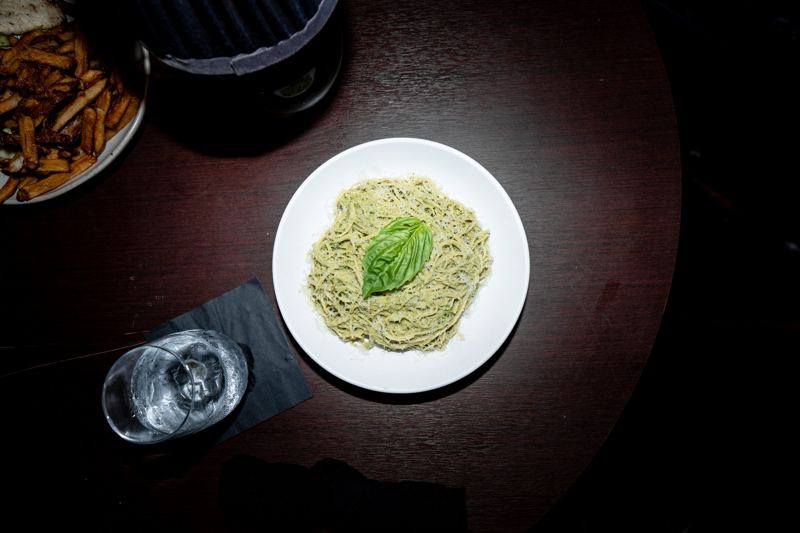 Pasta dish plated under warm lamp light